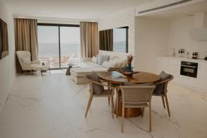 a living room with a table and a couch at Tagoo Hills in Mikonos