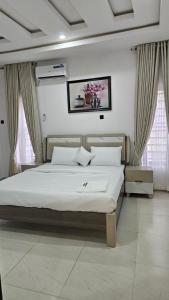 Un dormitorio con una cama grande en una habitación. en Mdcubehomesandproperties, 