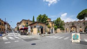 an empty city street with a green chair on a crosswalk at Leaning Tower Cozy 3 Bedroom Holiday Home in Pisa
