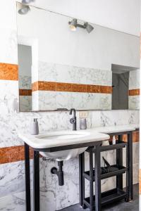 a bathroom with a sink and a mirror at Leaning Tower Cozy 3 Bedroom Holiday Home in Pisa +64 photos