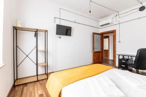 a bedroom with a bed and a tv on a wall at Leaning Tower Cozy 3 Bedroom Holiday Home in Pisa