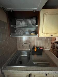 a kitchen counter with a sink and a sink at Appartamento Mansarda nel verde in Tavullia +15 photos