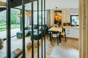 a kitchen and dining room with a table and chairs at Krzywe Pearl Chalets in Krywe