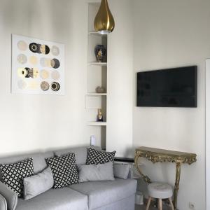 a living room with a couch and a table at Olives in Brussels