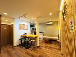 a kitchen and a living room with a table and stools at Tokyo Skytree House 4LDK, 2Bath, 9 Guests, 6min to Keisei Hikifune in Tokyo +16 photos