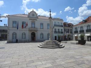 a building with a statue in the middle of a courtyard at the writer's neighbor I in Vila Franca de Xira