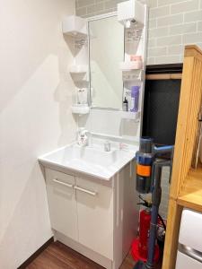a bathroom with a white sink and a mirror at Tokyo Skytree House 4LDK, 2Bath, 9 Guests, 6min to Keisei Hikifune in Tokyo