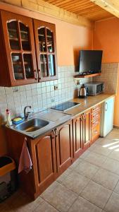a kitchen with a sink and a counter top at Apartmány Petronela Hrabušická Píla in Hrabušice +11 photos
