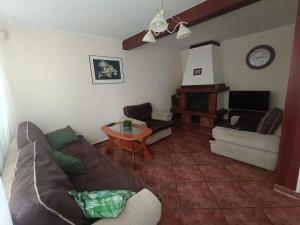 a living room with a couch and a table at Apartament I in Rowy
