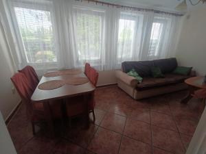 a living room with a table and a couch at Apartament I in Rowy