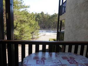 a balcony with a table and a view of a yard at Appartement T3 avec Balcon, 6 Couchages, Parking - FR-1-804-16 in Enchastrayes +2 photos