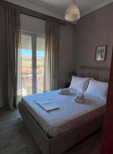 a bedroom with a bed and a large window at La mer in Moúdhros