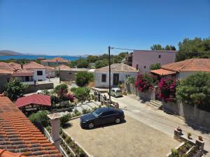 a car parked in a parking lot in a village at La mer in Moúdhros