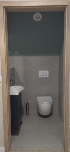 a bathroom with a toilet and a sink at Domek Leniuchowanie- kominek, ognisko, faktura in Krajno-Parcele +15 photos
