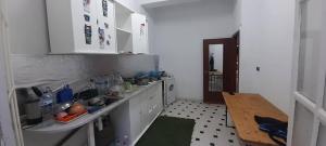 a kitchen with a sink and a table in it at Bab bhar sousse in Sousse +9 photos