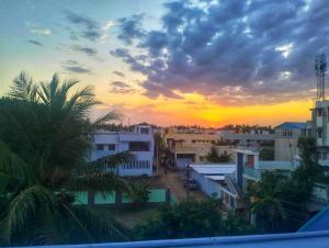 a view of a city with a sunset in the background at THIRUNALLAR Udhayam Residency INN in Thirunallar