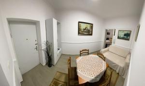 a living room with a table and a couch at City Center Bazaar Apartment in Tirana