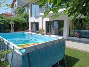 a swimming pool in the yard of a house at Villa Black Sea in Balchik