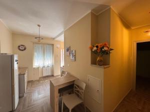 a living room with a vase of flowers on the wall at Conca D'Oro Guest House - Elisabetta in Rome