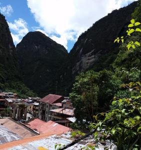 a view of a town with mountains in the background at Vista Waynapata 1 23 in Machu Picchu