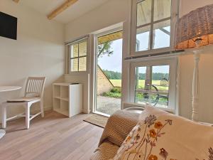 a living room with a couch and a window at BnB Nest & Weide in Nijeberkoop