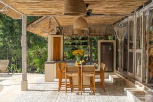a kitchen with a table and chairs on a patio at Uluwatu Lagoons - Retreat and Villas in Uluwatu