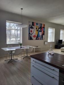 a living room with a table and a painting on the wall at Aste loft apartement in Aste