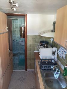 a small kitchen with a sink and a stove at The cave of Cyclops in Mákri +19 photos