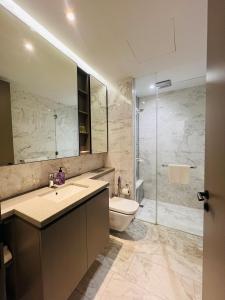 a bathroom with a sink and a toilet and a shower at Eaton Residences KLCC - Luxury Apartment in Kuala Lumpur