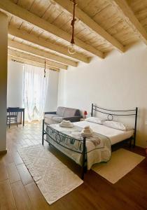 a bedroom with a bed and a couch at Austinu e Bingedda's Home in Ardara