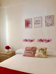 a bedroom with a white bed with flowers on the wall at La Dolce Vita in Bracciano