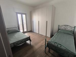 a room with two beds and a cabinet in it at Casa del Sol in Leporano