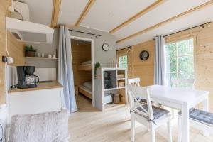 a tiny house with a dining room and a bedroom at Gustava Parken - 4 persons cottage in Hagfors