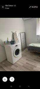 a washing machine in a room with a bed at Séjourner chez Roto in Cambronne-lès-Ribécourt