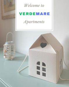a cardboard house with a heart on it on a table at Verdemare Apartments in Fano