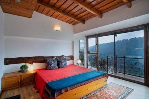a bedroom with a bed and a large window at Lake View 2BHK close to Mall Road l Bay Breeze in Nainital