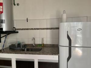 a kitchen with a sink and a refrigerator at Casa Vintage Bikes in Villa Marini