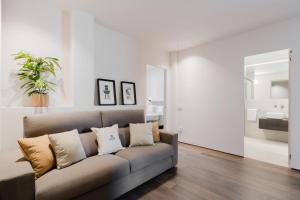 a living room with a couch with pillows at Siviglia 70 Apartment - Lecce Selection in Lecce +15 photos