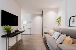a living room with a couch and a tv at Siviglia 70 Apartment - Lecce Selection in Lecce