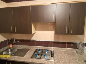 a kitchen with a sink and a counter top at Appartement Yasmine à Martil in Martil +9 photos