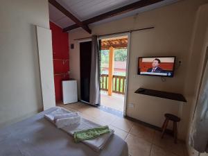 TV a/nebo společenská místnost v ubytování Suítes Praia das Toninhas