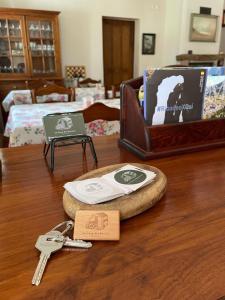 a wooden table with keys and a suitcase on it at Hotel Rural La Casa del Burrero in Castropol