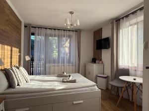 a bedroom with a large bed with a window at Rodzinna Ostoja in Zakopane