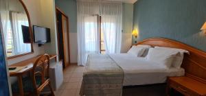 Postel nebo postele na pokoji v ubytování Hotel Rivadoro-Spiaggia ombrellone e lettini-Piscina-Parcheggio