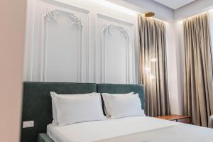 Postel nebo postele na pokoji v ubytování Mae Select Hotel