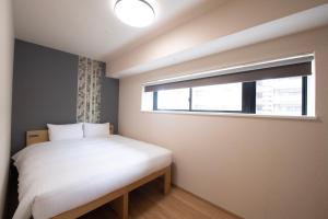 Postel nebo postele na pokoji v ubytování THE RISE Osaka Universal Bayside