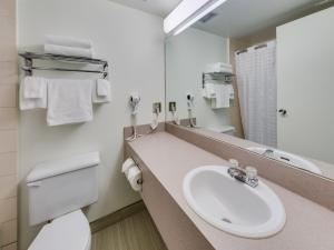 a bathroom with a sink, toilet and bathtub at Heritage Inn Hotel & Convention Centre - Brooks in Brooks