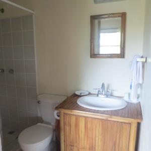 a bathroom with a sink and a toilet and a mirror at Hotel Lara's Planet in El Castillo de La Concepción +67 photos