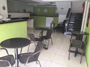 a restaurant with tables and chairs in a room at pousada do rei in Pedra de Guaratiba +9 photos
