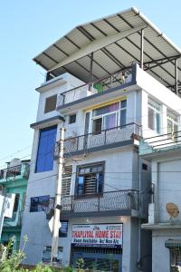 a building with a sign for a residential home stay at Thapliyal Homestay in Rishīkesh